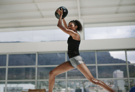 Sportswoman doing exercise with fitness ball