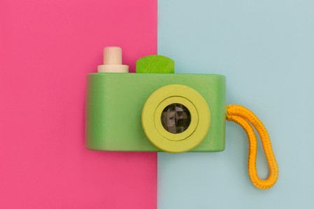 Retro camera on pink and blue background