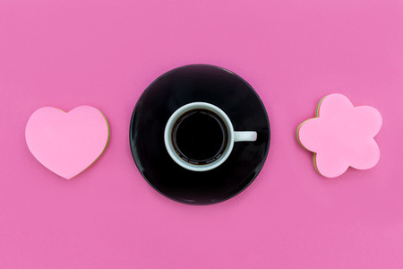 Coffee cup  saucer with love heart on pink background