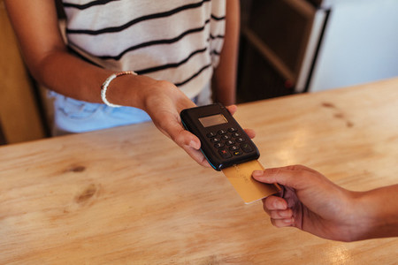 Woman making a wireless card transaction payment