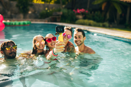 Group of friends catching memories from pool party