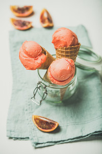 Refreshing summer blood orange ice cream served with orange slice