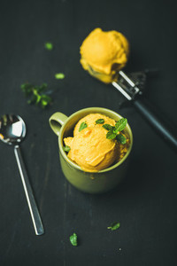 Refreshing Mango sorbet ice cream scoops with fresh mint