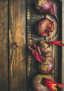 Raw organic purple beetroots in rustic wooden box  copy space