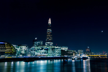 Modern London skyline at night on River Thames