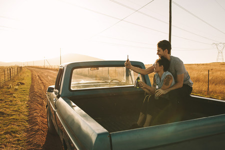Couple enjoying on a road trip in their pick up truck