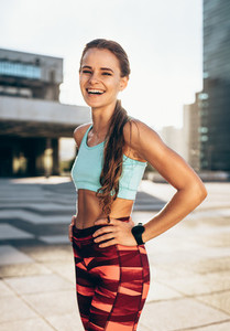 Sportswoman smiling outdoors in morning