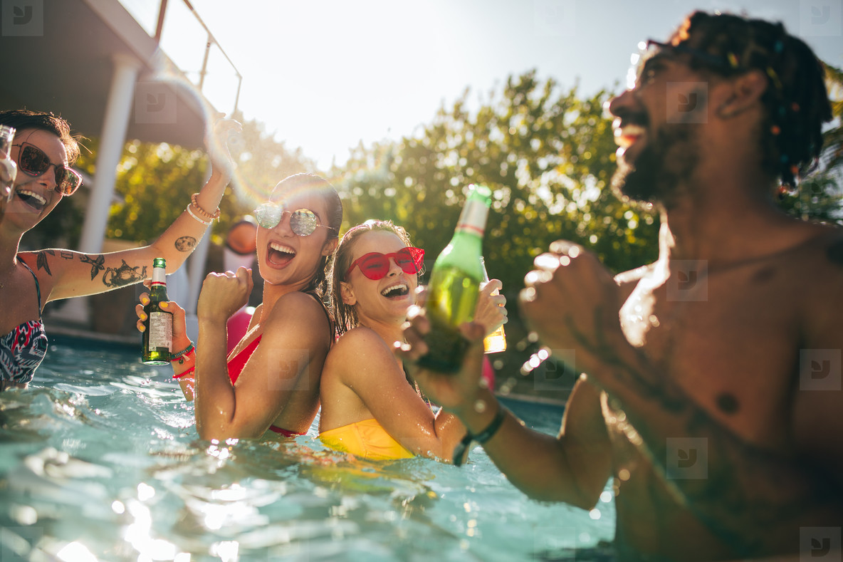 Group of happy friends at pool party with beers (143284) - YouWorkForThem.