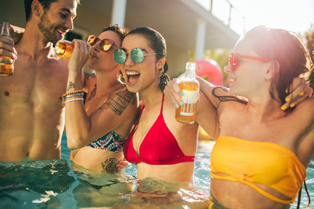 Group of friends partying in swimming pool