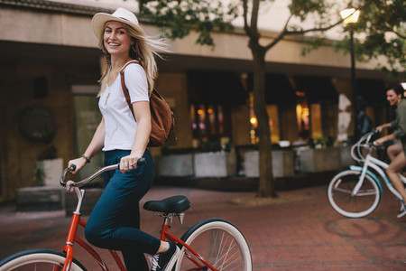 Beautiful woman riding bicycle in the city