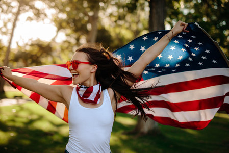 American woman with national flag at park