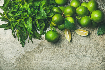 Flatlay of freshly picked limes and mint for making cocktail