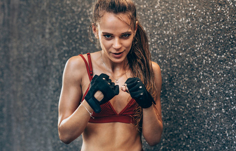 Female wearing gloves ready to fight