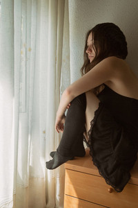 girl sitting on the bedside table