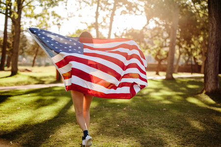 Girl running with American flag