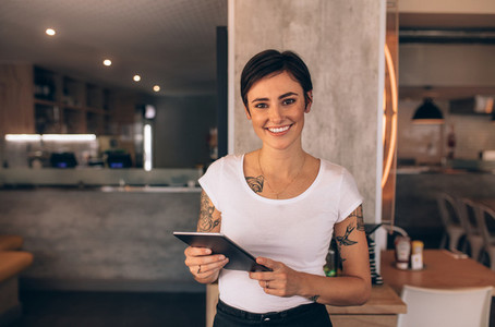 Female restaurant owner with a digital tablet