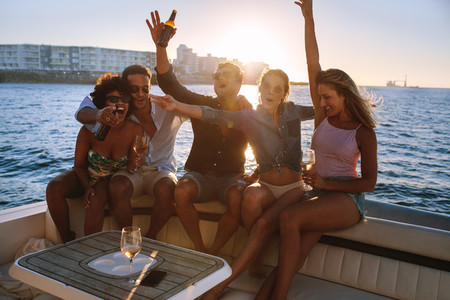 Cheerful friends partying on boat