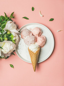 Strawberry and coconut ice cream  cones  white peonies  top view