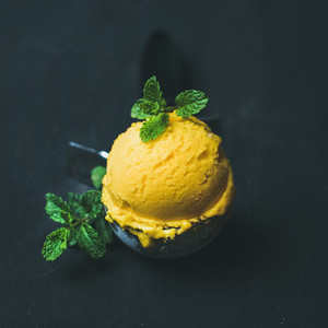Refreshing Mango sorbet ice cream scoop in scooper  square crop