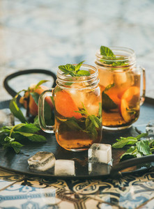 Summer refreshing cold peach ice tea with mint copy space