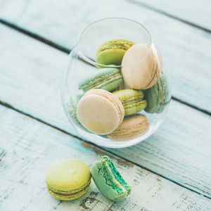 Colorful pastel French macaron biscuits in glass  copy space