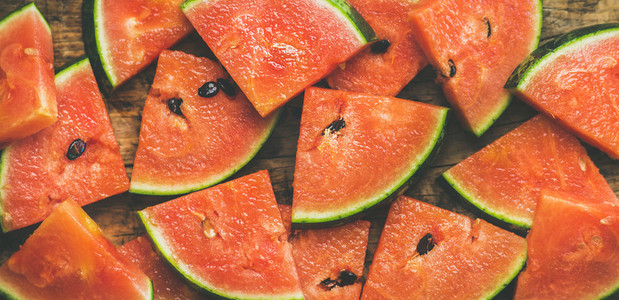Juicy fresh watermelon pieces on rustic wooden background