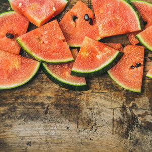 Juicy watermelon pieces over rustic wooden background  square crop