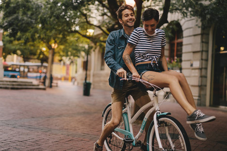 Happy couple on a bicycle in the city