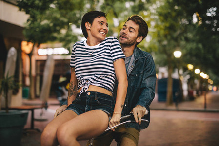 Couple enjoying on bicycle in the city