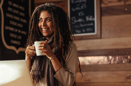 Woman enjoying a cup of coffee at a cafe