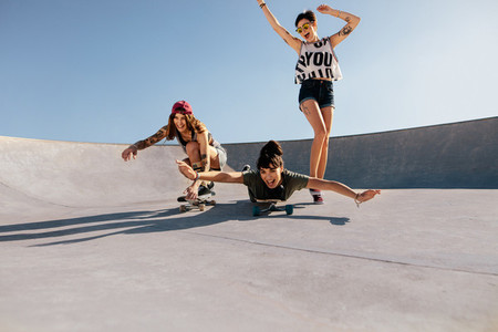 Group of women playing with skateboards