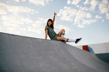 Female skateboarder enjoying a day at skate park
