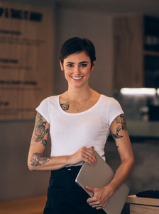 Beautiful female restaurateur with laptop