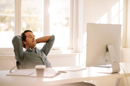 Freelance entrepreneur relaxing sitting in front of computer
