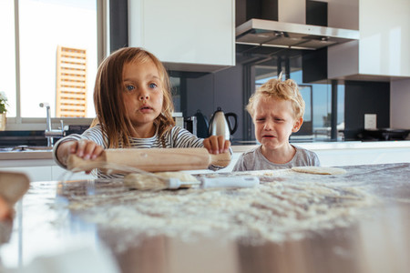 Children making cookies in kitchen