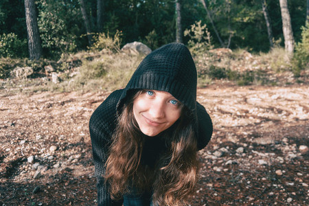 a girl with long hair and blue eyes in the mountains smiling wit