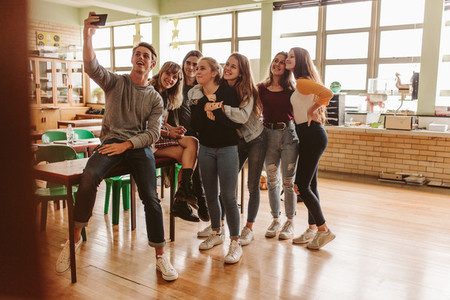 Students in classroom taking selfie