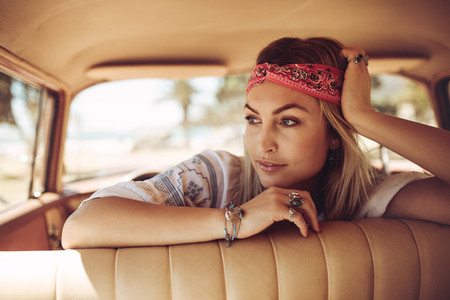 Beautiful woman in a car looking away and thinking
