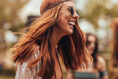 Laughing woman in retro look at music festival