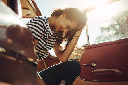 Woman sitting in the car and laughing