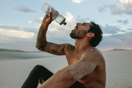 Athlete getting hydrated after workout in desert