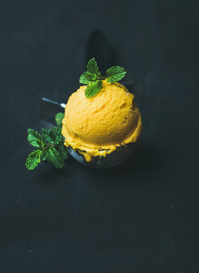Refreshing Mango sorbet ice cream scoop in scooper  copy space