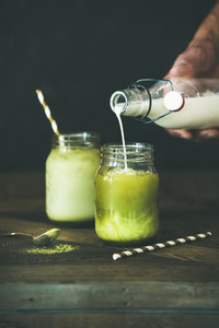 Cold refreshing summer iced coconut matcha latte drink