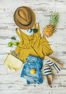 Colorful summer fashion outfit flat lay over pastel background