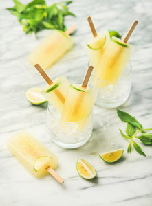 Summer refreshing lemonade popsicles with lime and mint