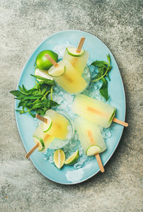 Summer refreshing lemonade popsicles with lime and mint on plate