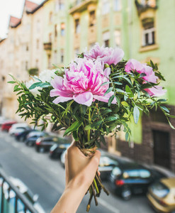 Bouquet of pink and white peony flowers street at background