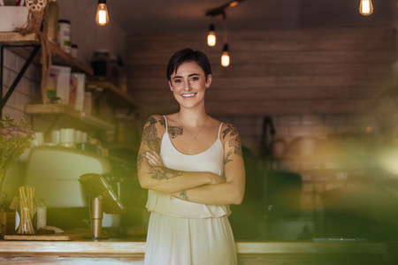 Woman entrepreneur standing at the counter of her cafe