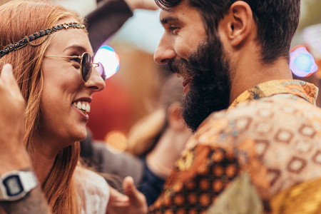Hippie couple dancing at music festival
