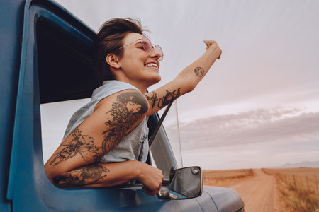 Attractive young woman enjoying on a road trip